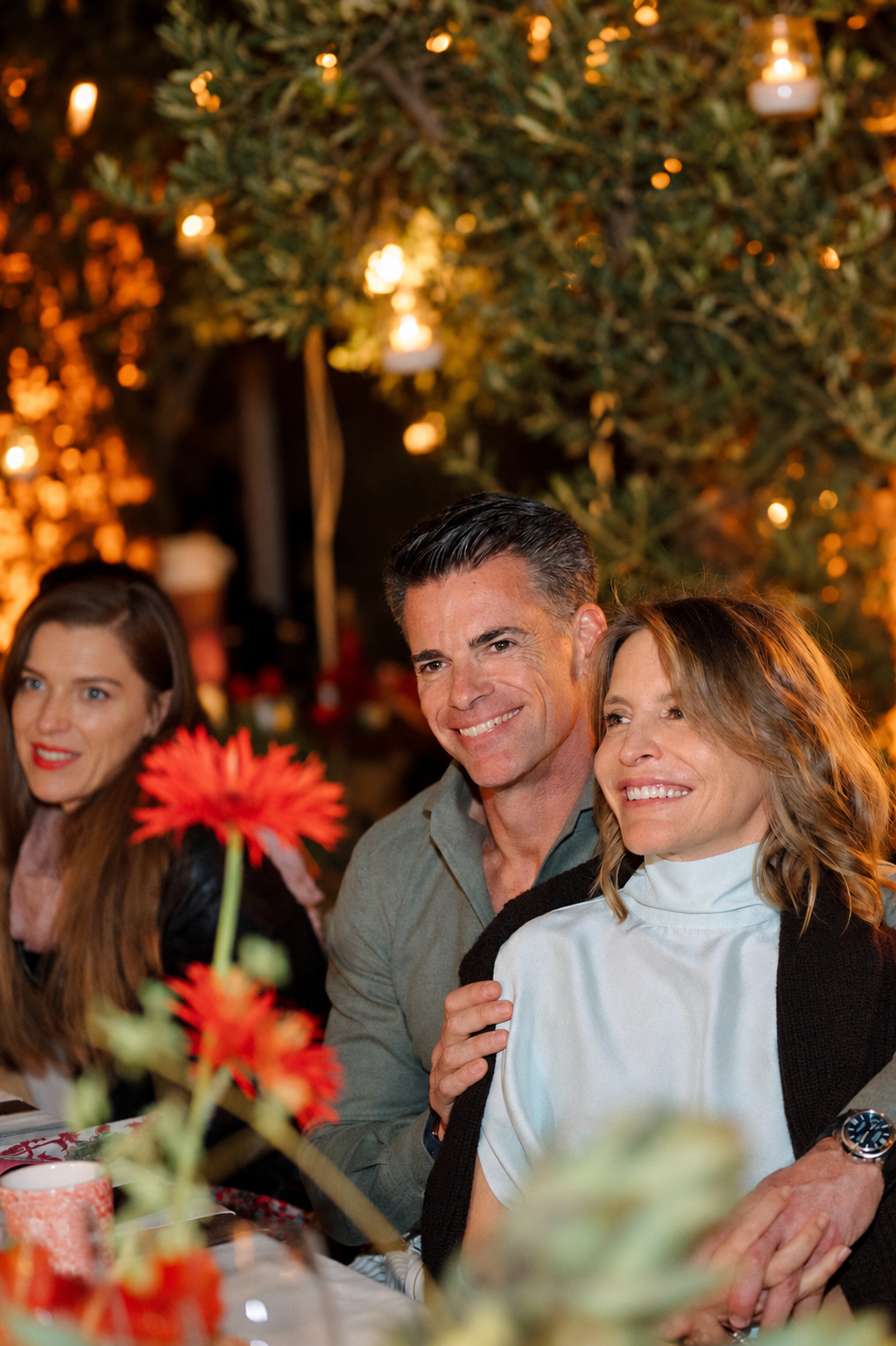 Sean Meyersfeld and Lea smiling together at an evening dinner under warm lights